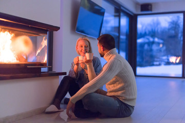 happy couple in front of fireplace