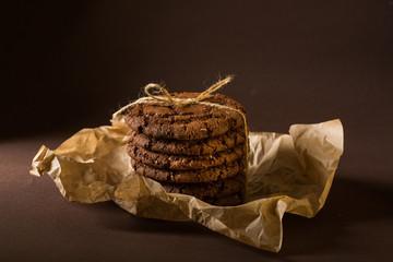 Stacked chocolate chip cookies on craft paper