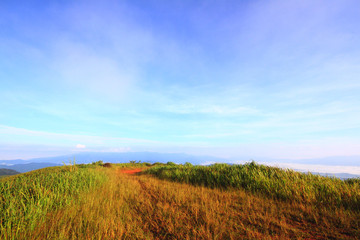 Naklejka premium View at a mountain range with morning fog in a mountain valley
