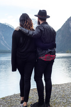 Hipster couple enjoys nature and scenic mountain lake in Austria