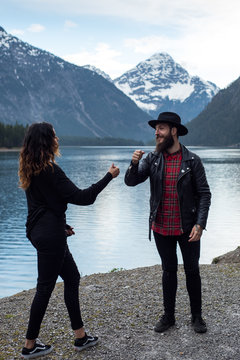 Hipster couple enjoys nature and scenic mountain lake in Austria