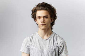 Picture of handsome young smoothly shaven Caucasian male actor with wavy hair and brown eyes...