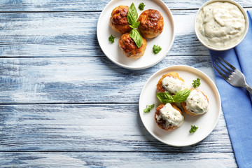 Delicious meatballs with sauce on table