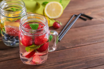 Mason jar of healthy infused water on wooden table