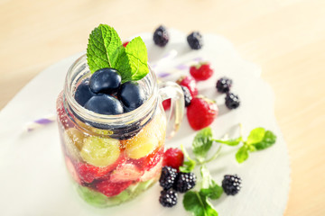 Mason jar of berry infused water on table