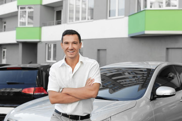 Fototapeta na wymiar Handsome man near car in the street