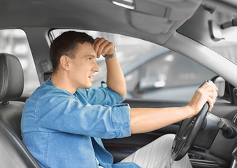 Handsome man driving a car