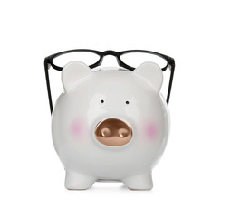 Cute piggy bank with glasses on white background