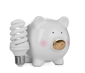Cute piggy bank with lamp on white background