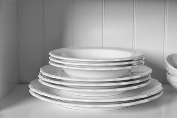 White storage stand with dishware in kitchen