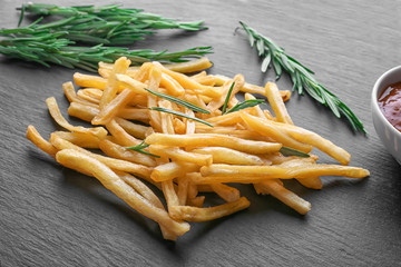 Yummy french fries on slate plate
