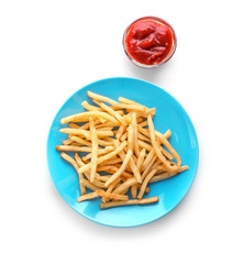 Plate with yummy french fries and sauce in small bowl on light background