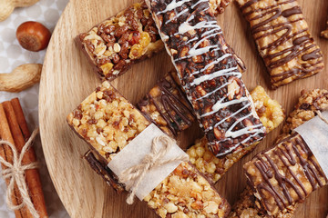 Cereal energy bars on wooden board, closeup
