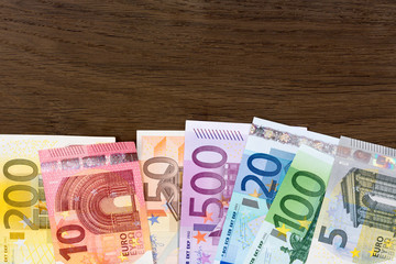 Money euro on wooden background.
