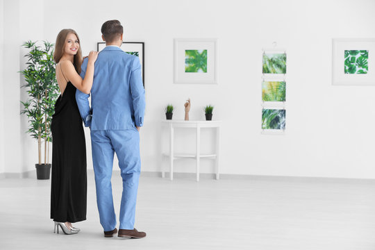 Couple in formal wear at art gallery exhibition