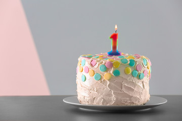 Cake with candle for first birthday on table