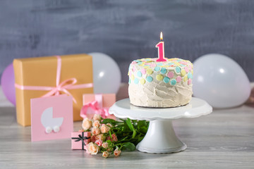 Cake with candle for first birthday on table