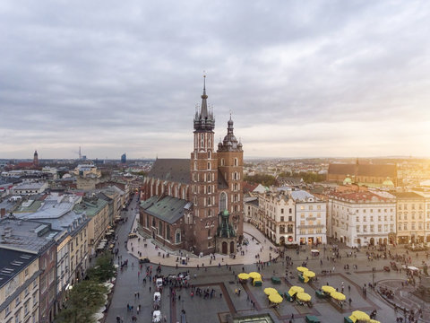 Aerial view on the main market square in Krakow and Marys Basilica. Sunset time in Poland.
