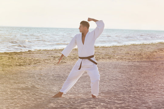 Young man practicing karate outdoors