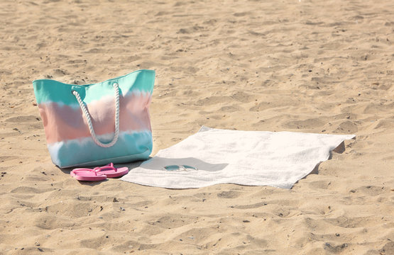 White Beach Towel With Sunglasses And Bag On Sand