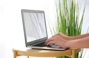 Young woman working with laptop at table