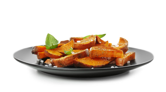 Plate with cooked sweet potato on white background