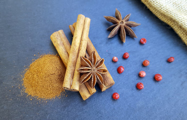Star anise, cinnamon sticks and powder with red pepper on the table
