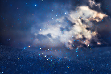 abstract stormy sky with clouds. glitter lights background. blue, black and silver. de focused.