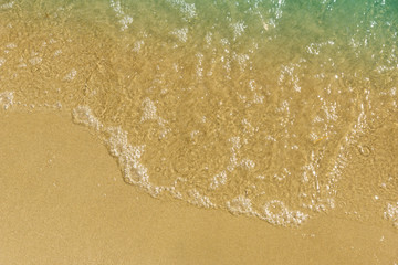 Soft waves on a sandy sea beach - top view, copy-paste