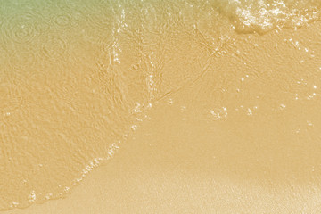 Soft waves on a sandy sea beach - top view, copy-paste