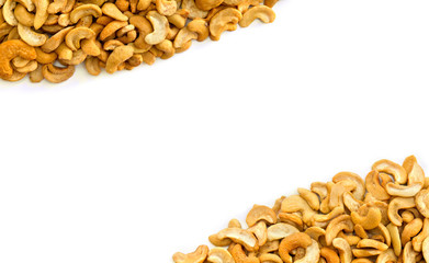 Roasted and salted Cashew nuts on a white background with space for text. Top view, flat lay.