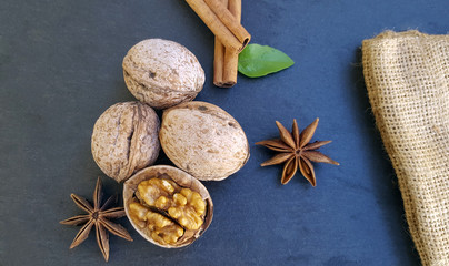 Fototapeta na wymiar Cinnamon sticks, anise star and walnuts on the table