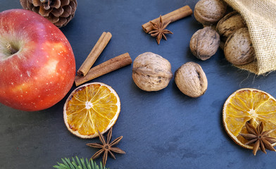Apple ,dried orange slices, cinnamon sticks and walnuts