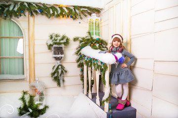 little girl is playing in the winter yard