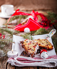 Dresdnen Stollen is a Traditional German Cake with raisins on a light knitted background.Gift for Christmas.Vintage style.Fruit cake for the Holiday. German, European festive dessert.