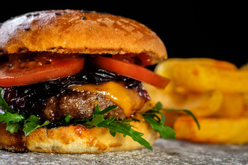 Fresh juicy delicious homemade burger. Hamburger with meat and fresh herbs.