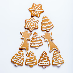 Christmas cookie with sugar glaze spread form of Christmas tree on a white background, square, copyspace, flat lay
