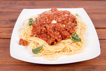 Spaghetti bolognese on a wooden background