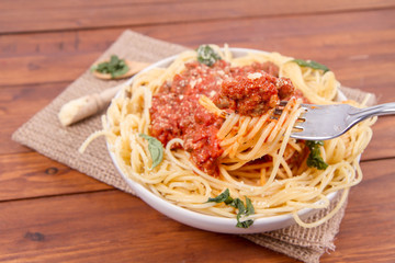 Spaghetti bolognese on a wooden background