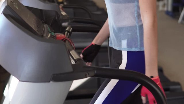 young woman walks on a treadmill at the gym. cardio exercises in the gym