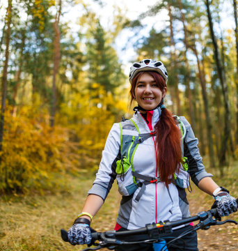 Image ofa girl in helmet riding bicycle
