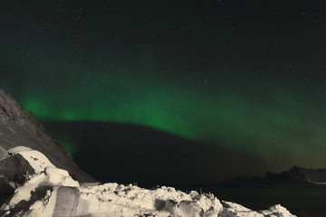 Fototapeta na wymiar Aurora borealis-Polar lights-Northern lights over Ytresandheia-Roren mounts. Yttresand-Flakstadoya island-Lofoten-Norway. 0470