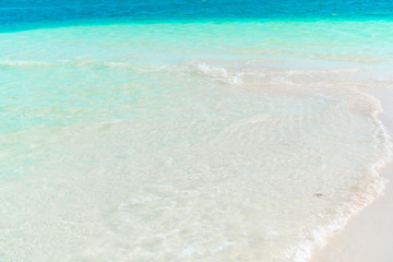 Fototapeta na wymiar Idyllic tropical beach with white sand, turquoise ocean water and beautiful colorful sky on Caribbean island