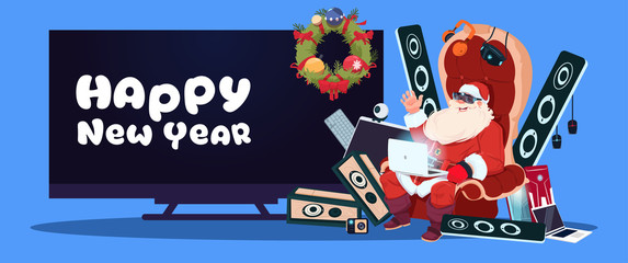 Happy New Year Banner With Santa Claus Sitting With Modern Electronics Gadgets And Plasma Tv On Background Vector Illustration