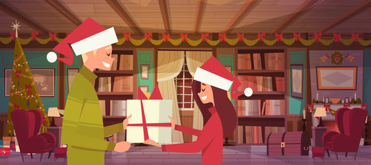 Couple In Santa Hats Holding Present Box Celebrate Christmas Together At Home, Cute Man And Woman Greeting Happy New Year Poster Design Vector Illustration