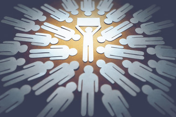 A person with an idea holds a banner in his hand surrounded by many people. The concept of...