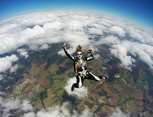 Woman costumed skeleton in free fall. Skydiving Happy Halloween.
