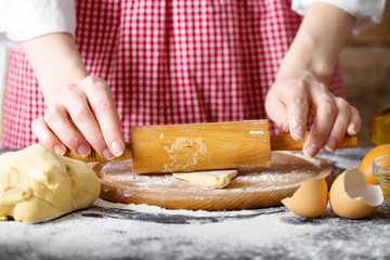 Making dough by female hands at bakery