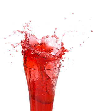 Splash of pomegranate juice in a glass, isolated on a white background