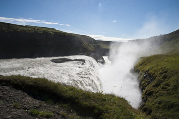 Typical Icelandic landscape of Gullfos Falls, a wild nature of rocks and shrubs.